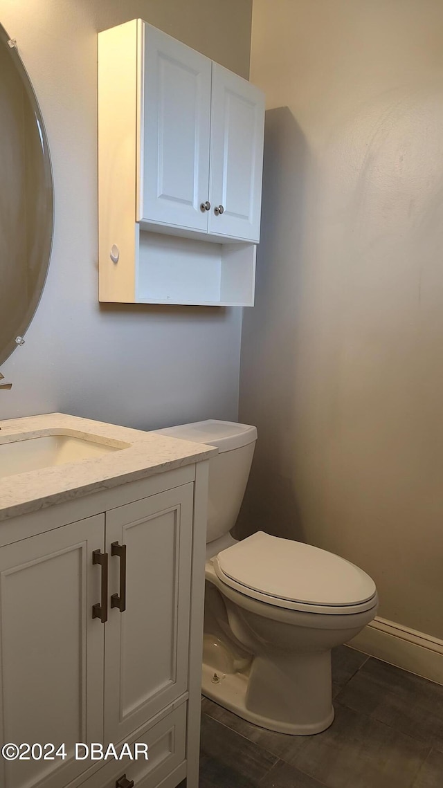 bathroom featuring toilet, vanity, and tile patterned floors