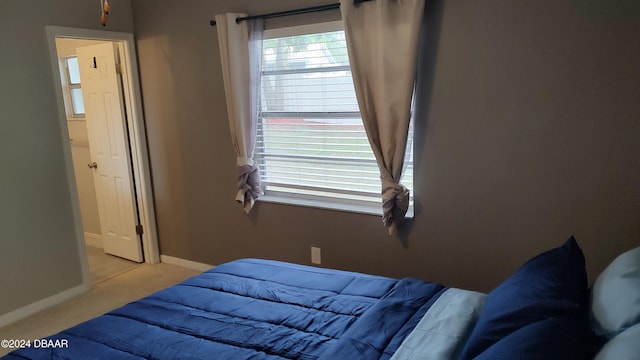 bedroom with light colored carpet