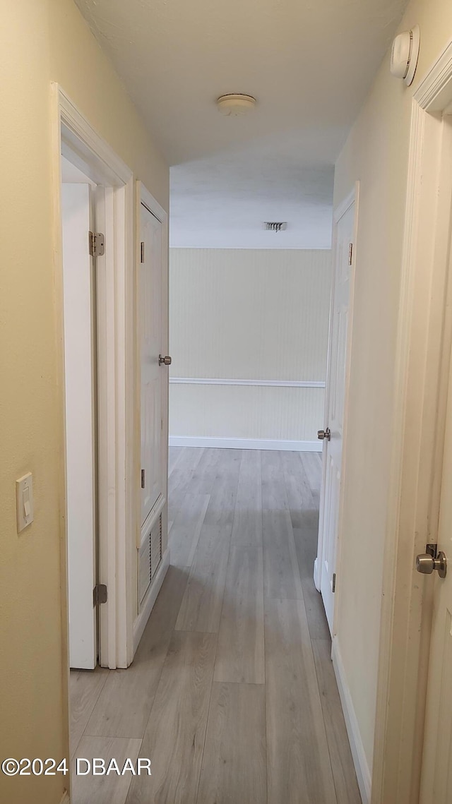 corridor with light wood-type flooring