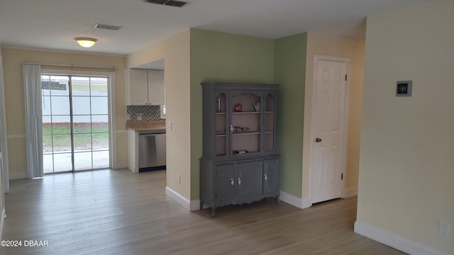 unfurnished dining area with light wood-type flooring