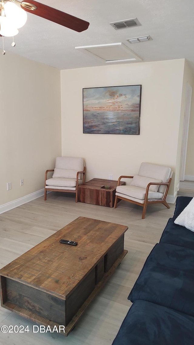 living room with ceiling fan and light hardwood / wood-style flooring