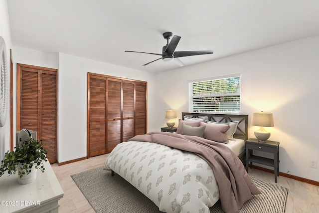 156 S Woodbridge Cir, Daytona Beach, FL 32119 - bedroom featuring two closets, baseboards, and a ceiling fan