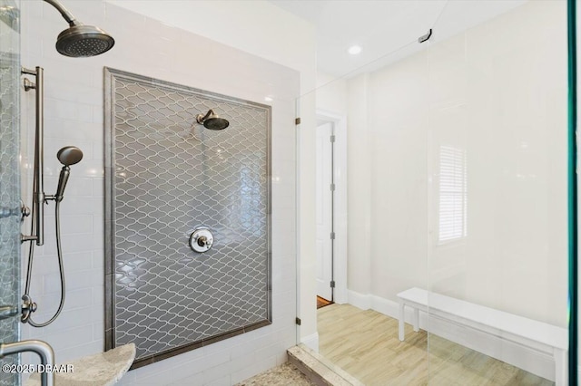 bathroom with baseboards and a stall shower