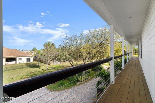 deck featuring a lawn and fence