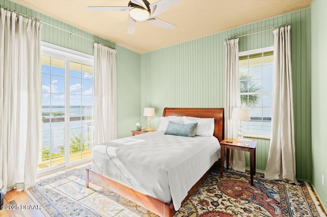 bedroom with a ceiling fan and wood finished floors