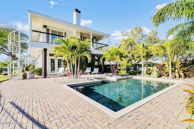 view of swimming pool featuring a patio area, a fenced in pool, and stairs