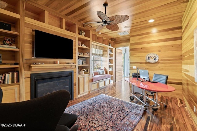 3212 John Anderson Dr, Ormond Beach, FL 32176 - office featuring wood finished floors, a ceiling fan, wood walls, a glass covered fireplace, and wooden ceiling