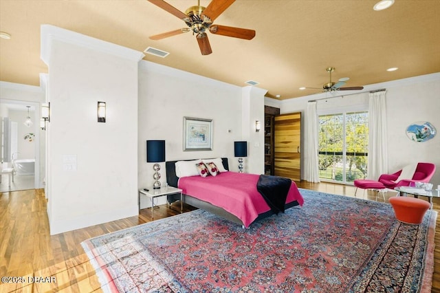 bedroom with recessed lighting, visible vents, wood finished floors, and crown molding