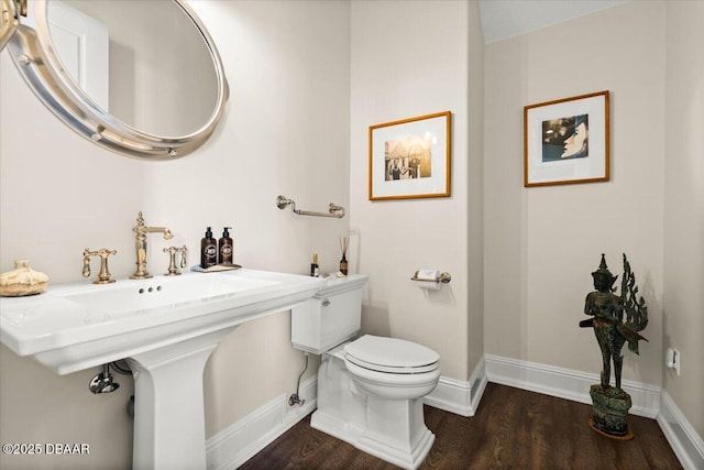 3212 John Anderson Dr, Ormond Beach, FL 32176 - half bath featuring wood finished floors, toilet, and baseboards
