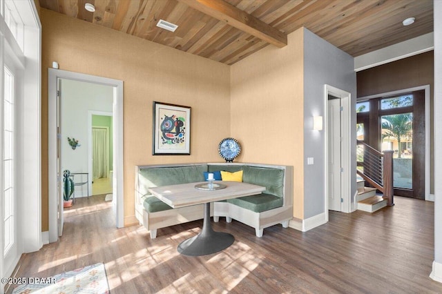 dining space with wood ceiling, visible vents, breakfast area, and wood finished floors