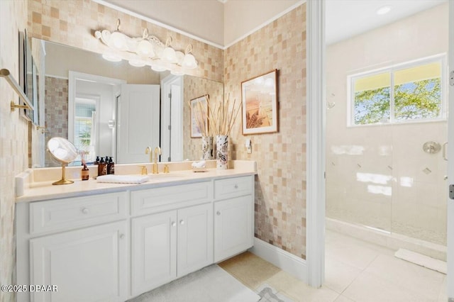 bathroom with vanity, tile patterned floors, and a tile shower