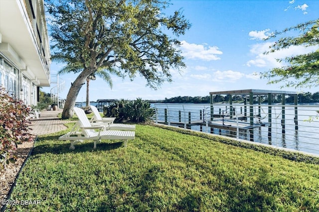 dock area featuring a lawn and a water view