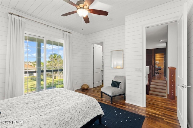 bedroom with multiple windows, a ceiling fan, and wood finished floors