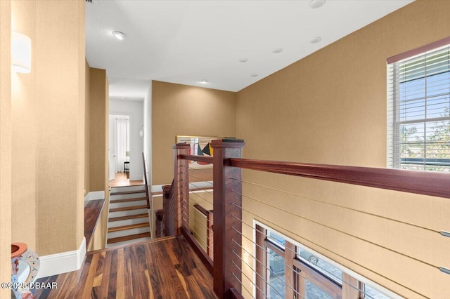 3212 John Anderson Dr, Ormond Beach, FL 32176 - corridor featuring baseboards, an upstairs landing, and wood finished floors