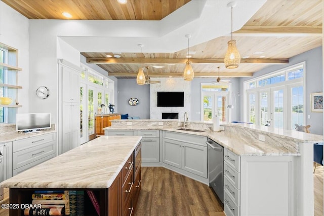 kitchen with a sink, wooden ceiling, french doors, and a spacious island