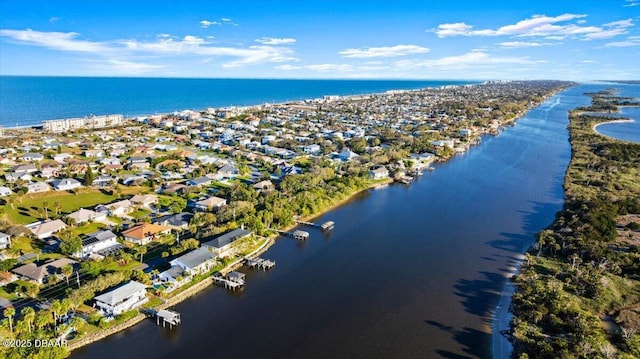 drone / aerial view featuring a residential view and a water view