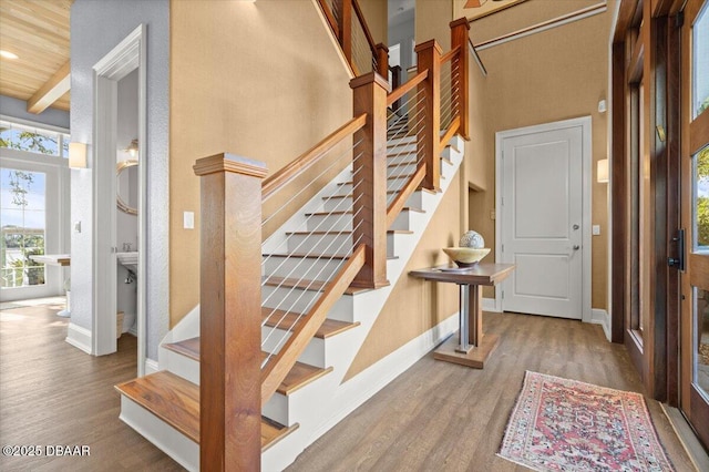 3212 John Anderson Dr, Ormond Beach, FL 32176 - foyer with stairs, wood finished floors, baseboards, a towering ceiling, and recessed lighting
