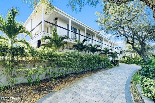 view of property featuring decorative driveway