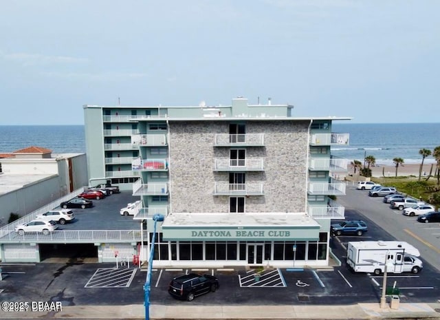 view of property with a water view and uncovered parking