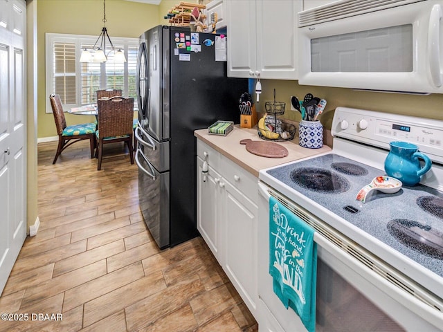 kitchen with light countertops, white appliances, white cabinetry, and light wood-style flooring