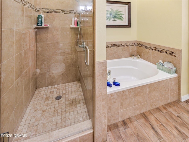bathroom featuring a bath and a stall shower