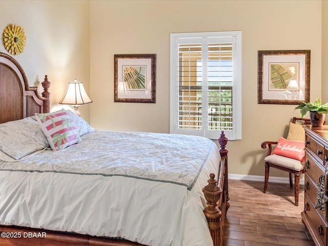 bedroom featuring baseboards and wood finished floors