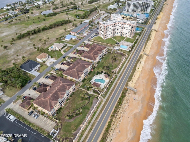 birds eye view of property featuring a view of the beach and a water view