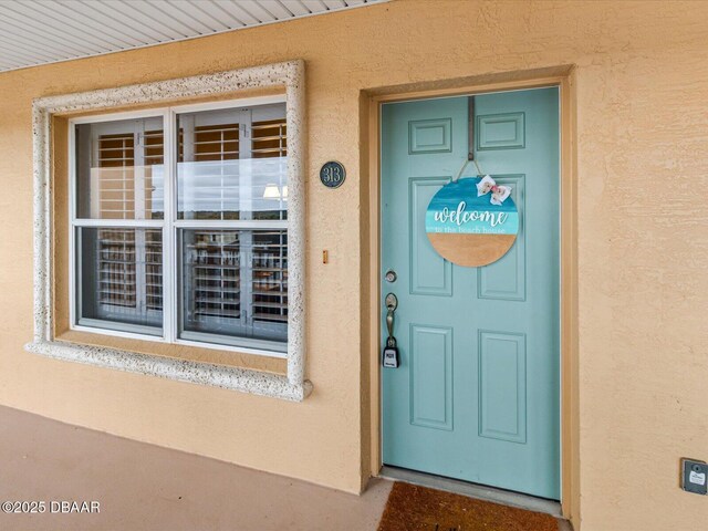 doorway to property with stucco siding