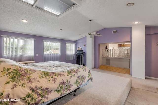 carpeted bedroom with vaulted ceiling and ceiling fan