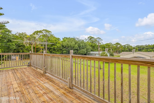 wooden terrace with a lawn