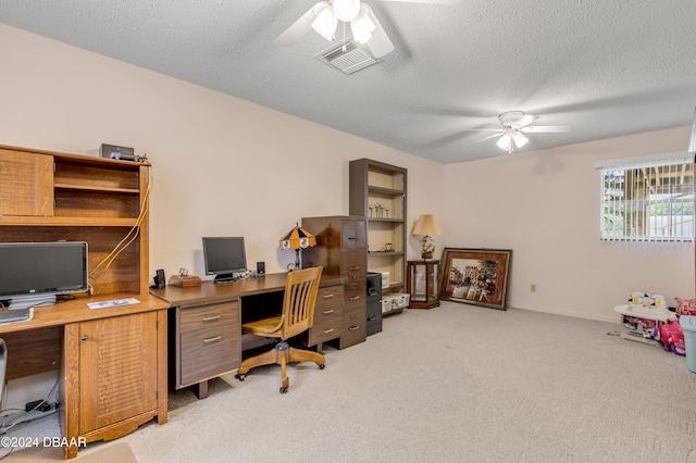 office area with ceiling fan, light colored carpet, and a textured ceiling