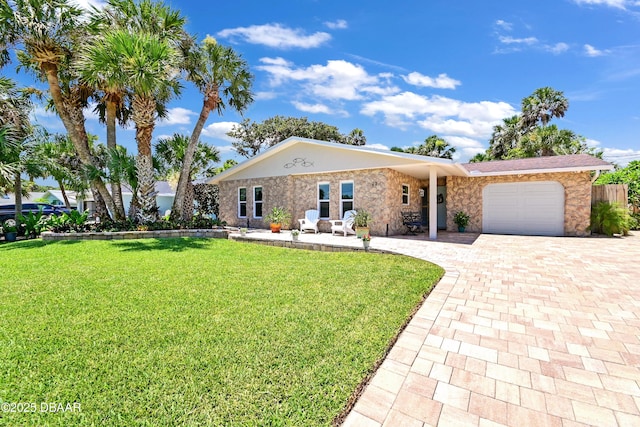 22 Sand Dune Dr, New Smyrna Beach, FL 32169 - ranch-style home with decorative driveway, a garage, and a front lawn