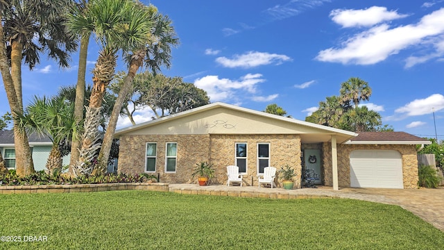 22 Sand Dune Dr, New Smyrna Beach, FL 32169 - single story home featuring a garage, a front lawn, driveway, stone siding, and stucco siding