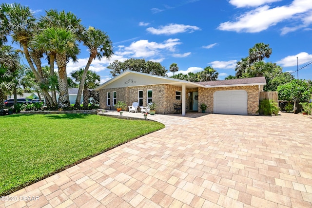 22 Sand Dune Dr, New Smyrna Beach, FL 32169 - ranch-style home featuring decorative driveway and a garage