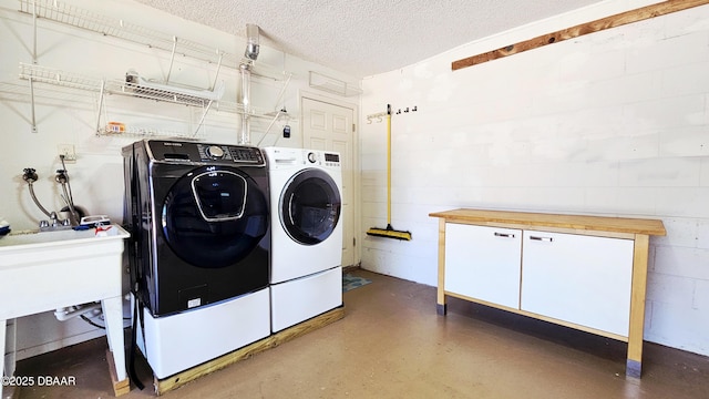 22 Sand Dune Dr, New Smyrna Beach, FL 32169 - laundry room featuring washing machine and dryer and a textured ceiling