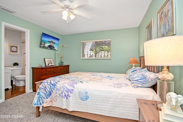 22 Sand Dune Dr, New Smyrna Beach, FL 32169 - carpeted bedroom with ensuite bathroom and ceiling fan