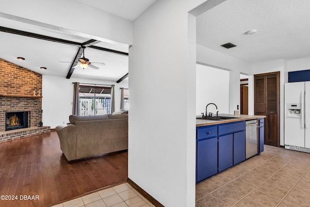75 Sycamore Cir, Ormond Beach, FL 32174 - kitchen with light hardwood / wood-style floors, sink, a textured ceiling, white refrigerator with ice dispenser, and dishwasher