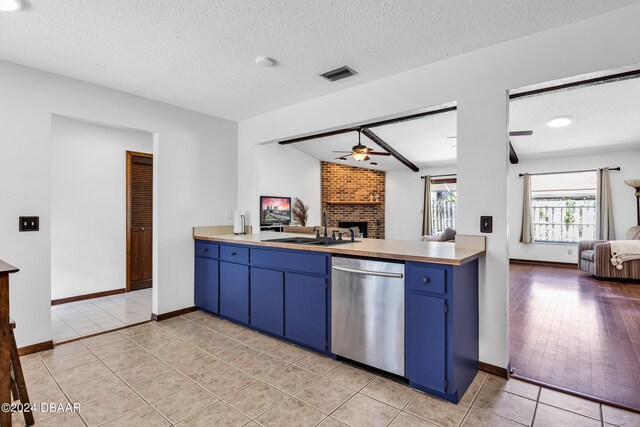 75 Sycamore Cir, Ormond Beach, FL 32174 - kitchen with dishwasher, light wood-type flooring, sink, and a textured ceiling