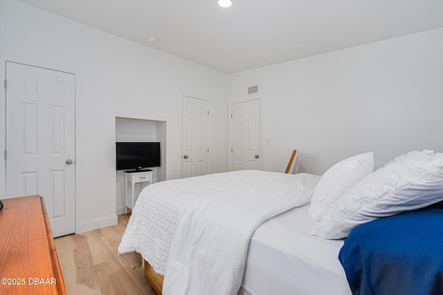 bedroom with light hardwood / wood-style floors