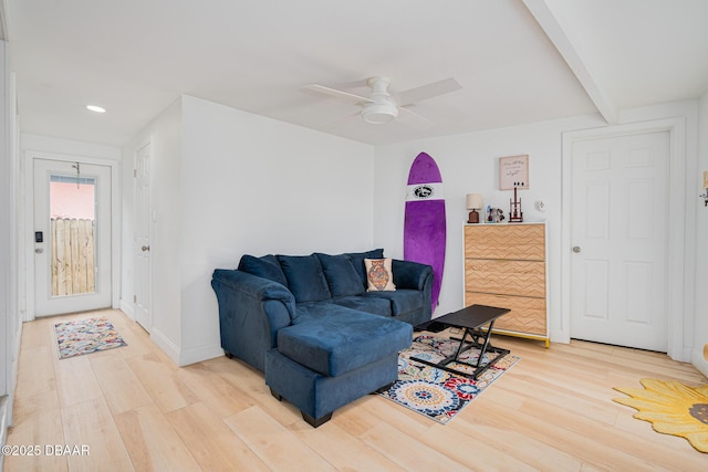 living room with beam ceiling, ceiling fan, and wood-type flooring