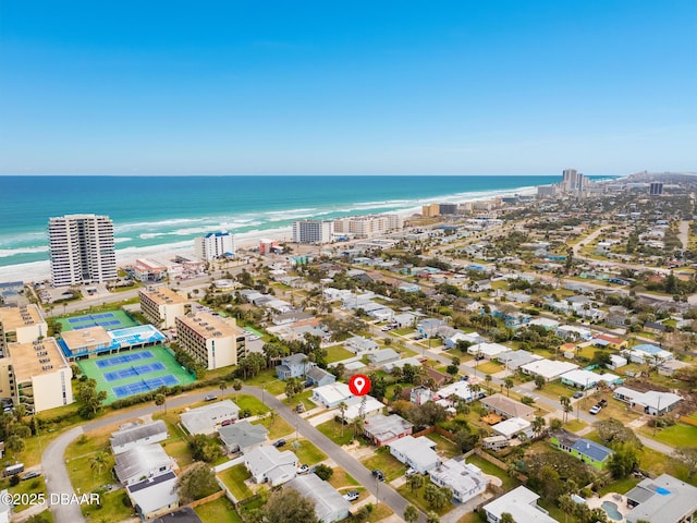 birds eye view of property with a water view and a view of the beach