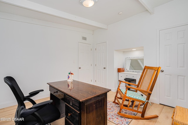 office with light hardwood / wood-style flooring and beam ceiling