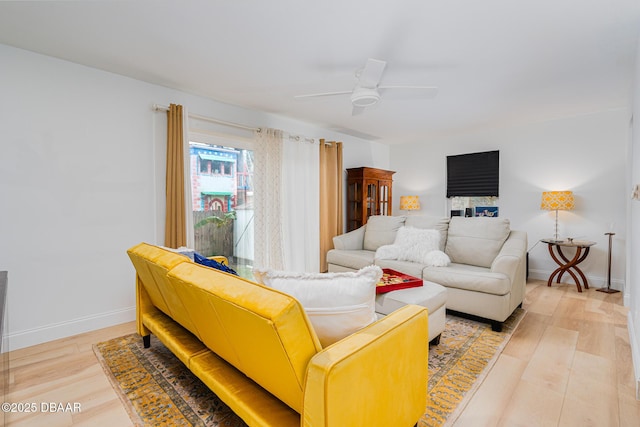 living room with ceiling fan and light hardwood / wood-style floors