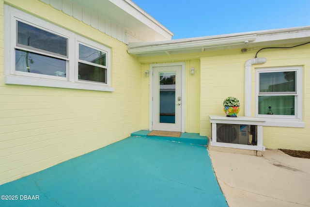 property entrance featuring ac unit and a patio