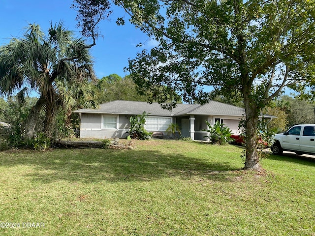 ranch-style home with a front lawn