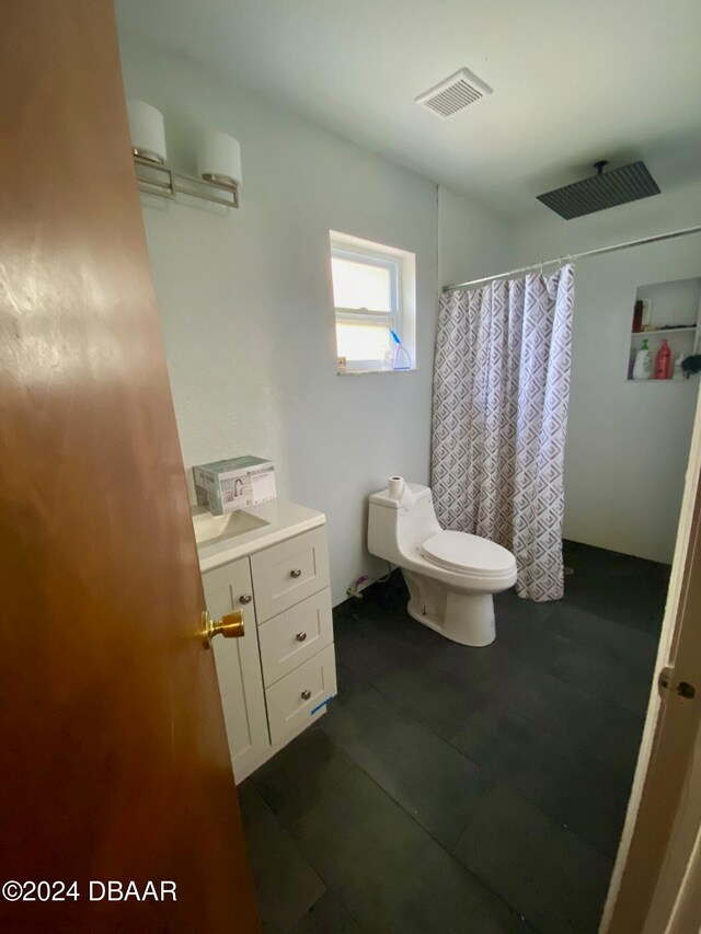 bathroom with curtained shower and toilet