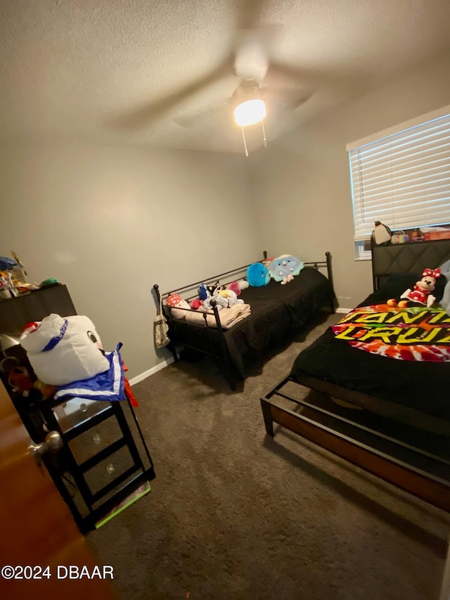 bedroom with carpet flooring, a textured ceiling, and ceiling fan