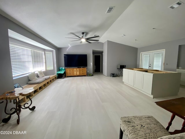 living room with light wood-type flooring, ceiling fan, and vaulted ceiling