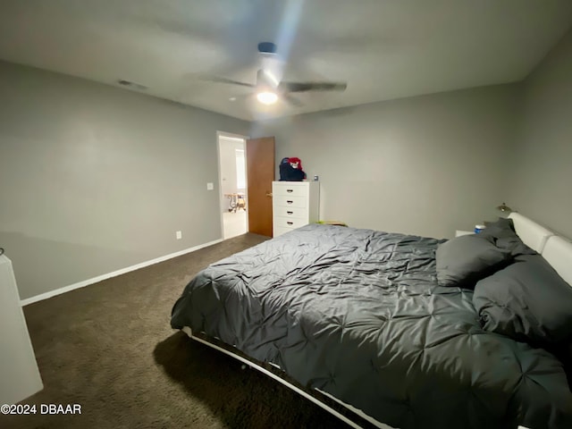 bedroom with dark colored carpet and ceiling fan