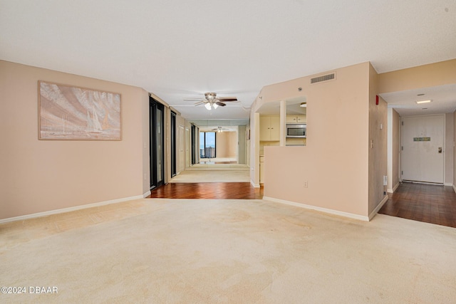 empty room featuring carpet flooring and ceiling fan